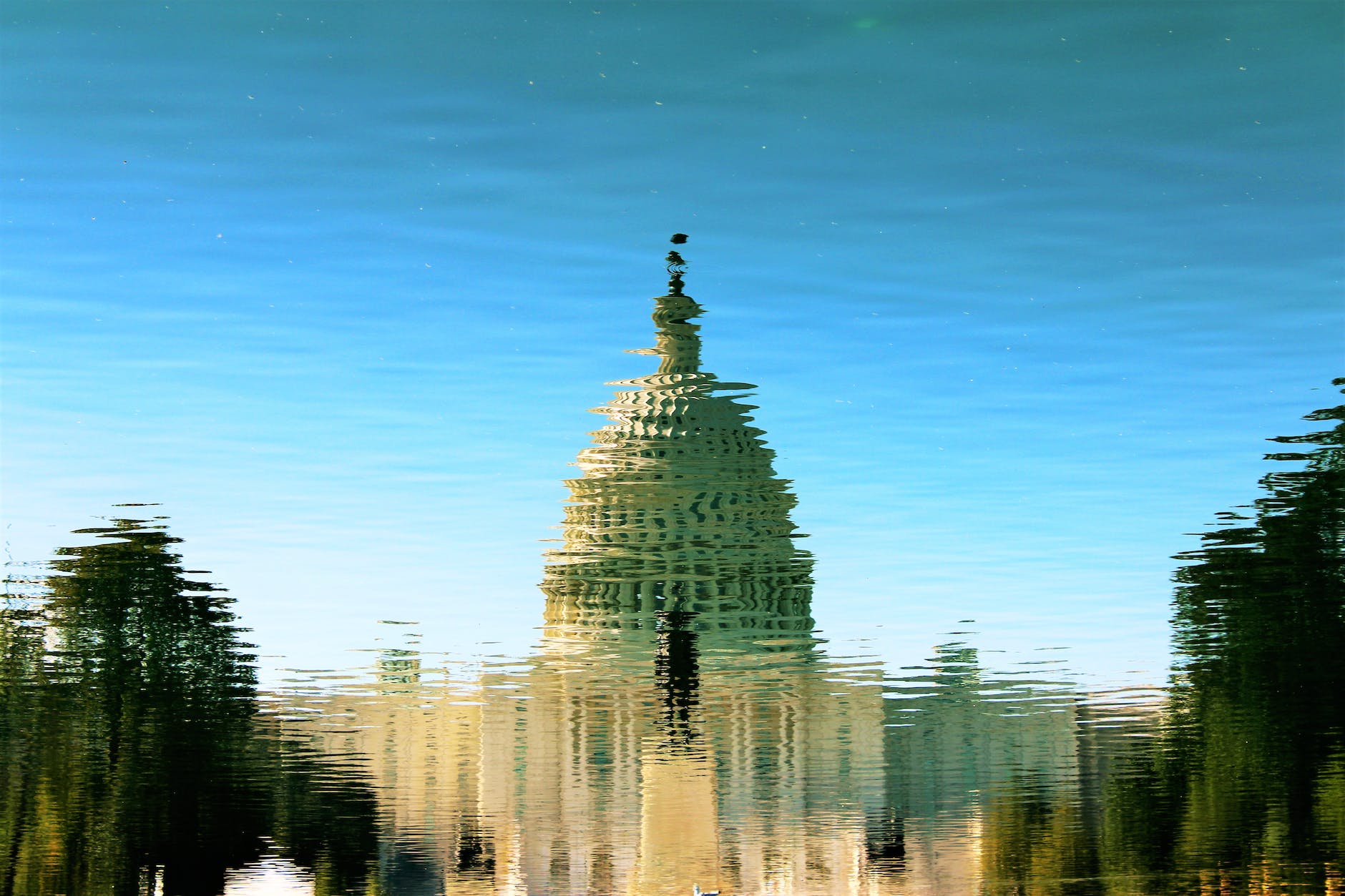 reflection of gray mosque on water